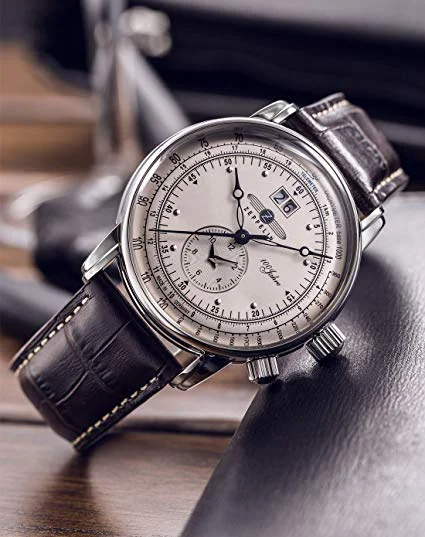 german watch in black leather wristband.