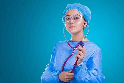 A female nurse wearing surgical robe, eyeglasses, and a stethoscope.