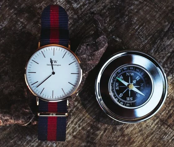 A firefighter's watch with blue and red wristband and supplementary features such as compass.