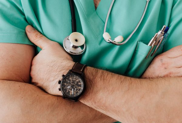 A medical professional wearing a wristwatch.