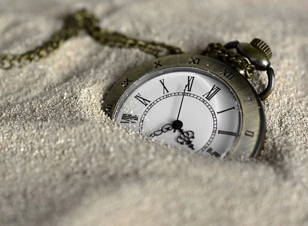 An analog dive watch soak in the sand.