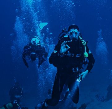 A diver doing the okay sign while underwater.