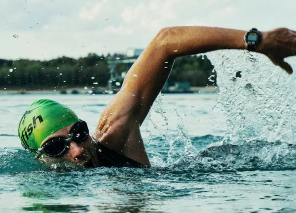 A swimmer wearing an underwater watch while swimming in the sea.